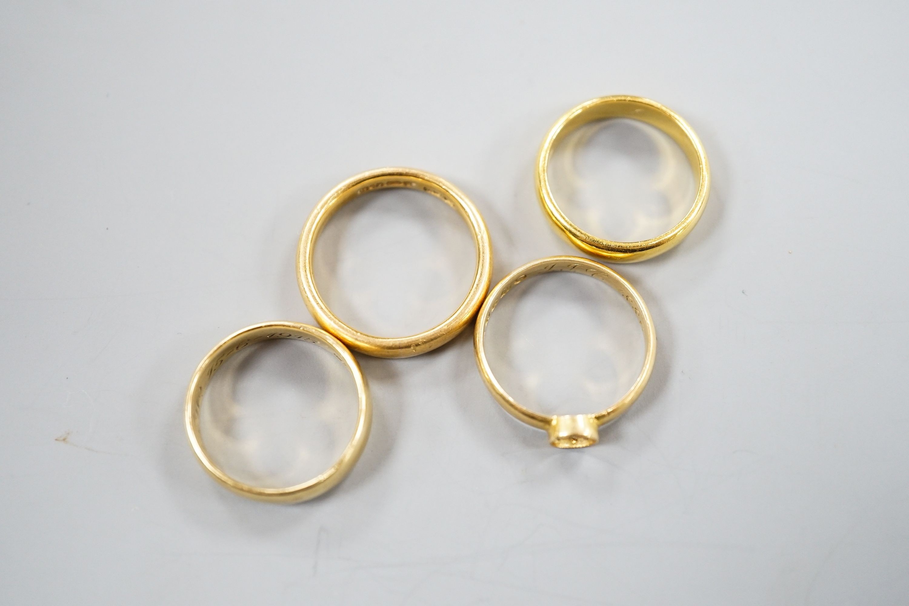 Two 22ct gold wedding bands, 10.3 grams, a George V 18ct gold wedding band and a Victorian 18ct gold shank, 6.6 grams.
